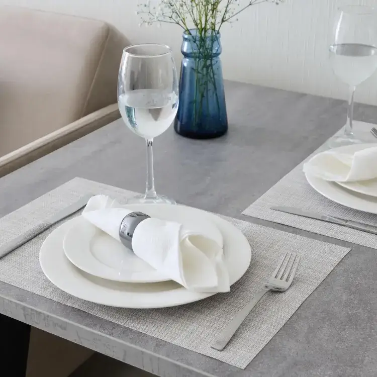 An Elegant Dining Setup Featuring Glassware and Luxurious Cloth Napkins for a Delightful Experience